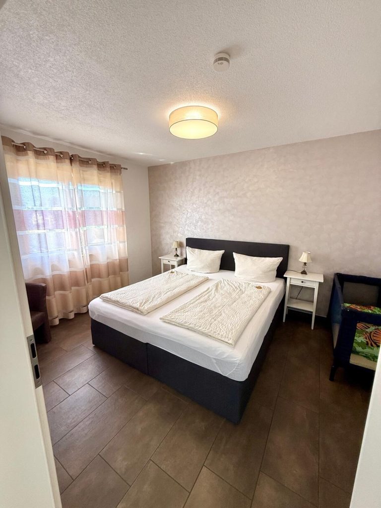 Bedroom with box-spring bed in the apartment in Rust